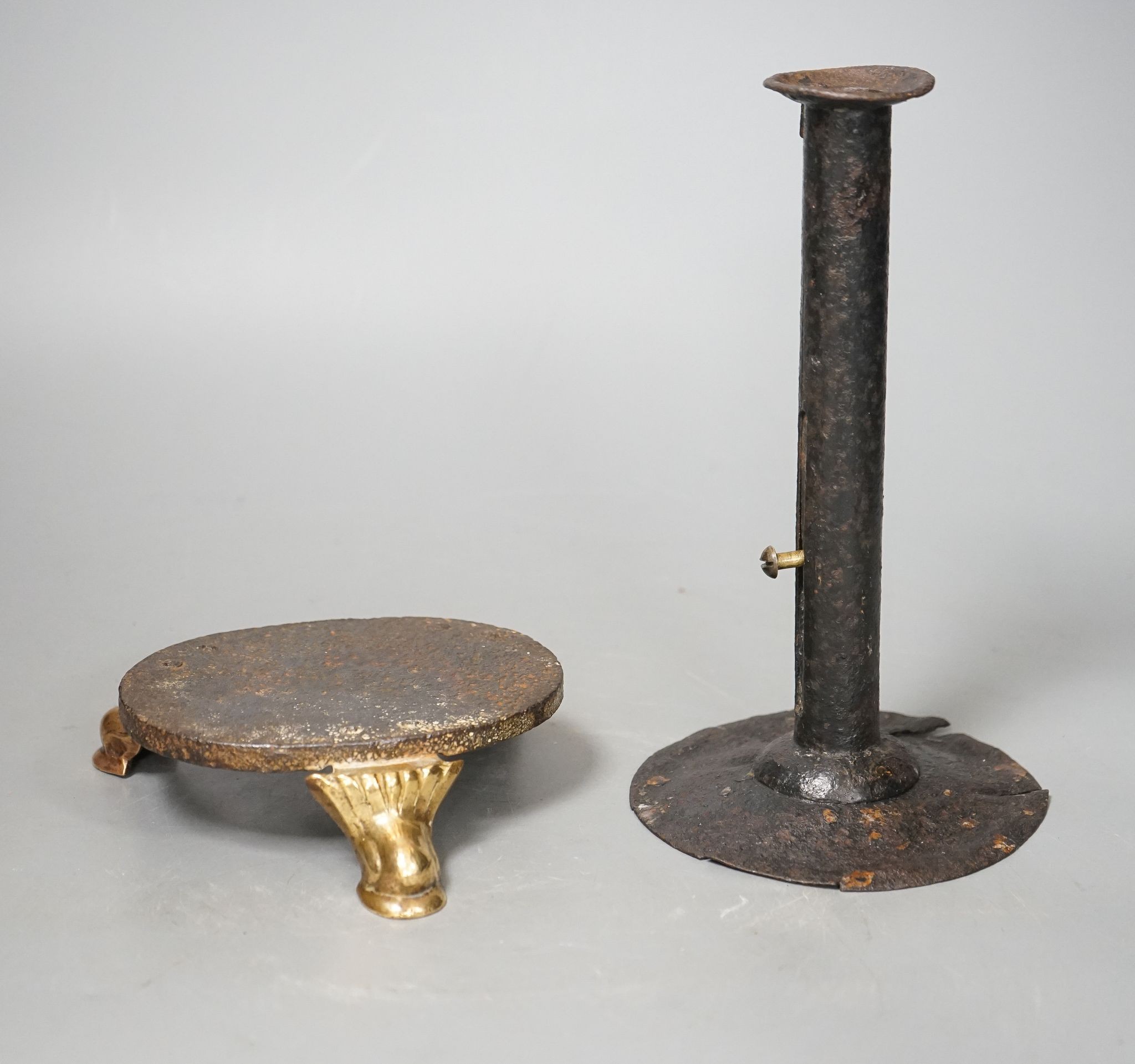 An 18th century provincial tole candlestick and an 18th century iron and brass oval stand, candlestick 20cm